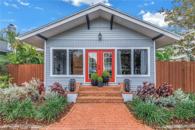 back of house featuring fence and french doors