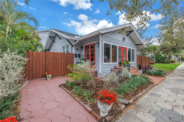 view of front of house with french doors and fence