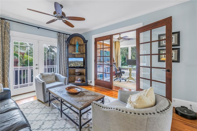 interior space with french doors, crown molding, baseboards, and wood finished floors