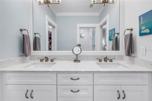 bathroom featuring double vanity, ornamental molding, a sink, and visible vents