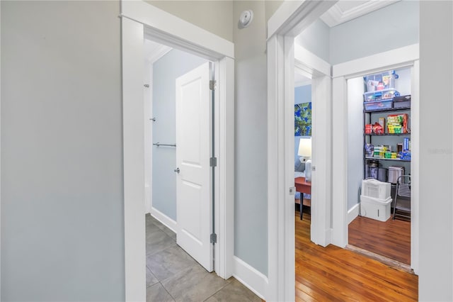 hall with light wood-style floors and baseboards