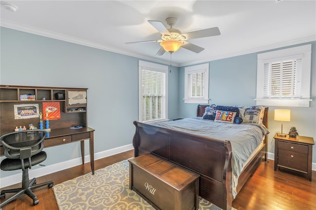 bedroom with baseboards, crown molding, and hardwood / wood-style floors