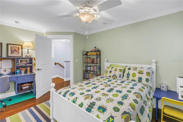 bedroom featuring ornamental molding, ceiling fan, and wood finished floors