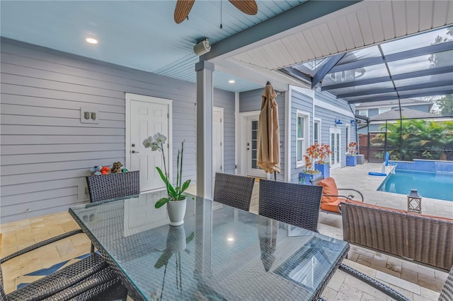 view of patio featuring a ceiling fan, outdoor dining space, glass enclosure, an outdoor pool, and an outdoor living space