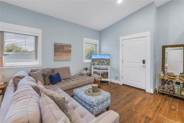 living room with vaulted ceiling, wood finished floors, and baseboards