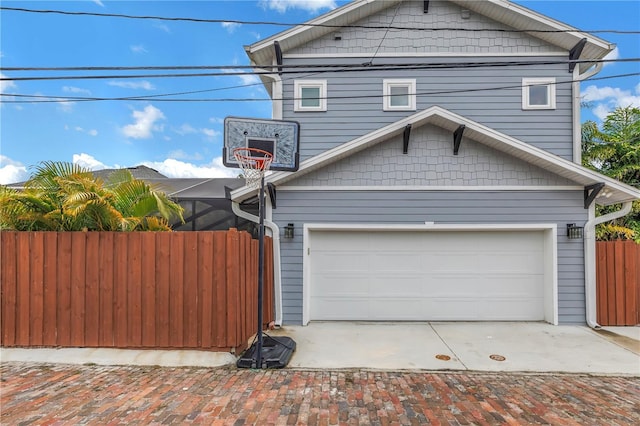 view of side of property with a garage and fence