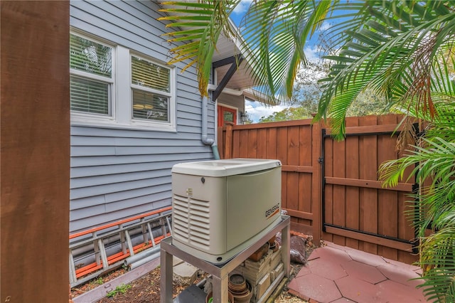 exterior details featuring a power unit and fence