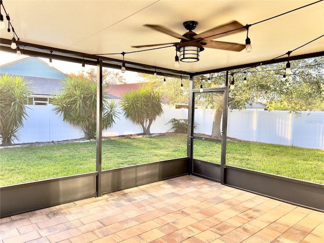 unfurnished sunroom with ceiling fan and a wealth of natural light