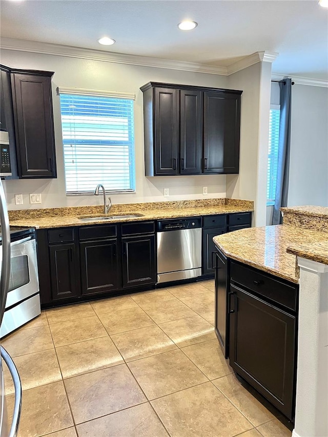 kitchen featuring light tile patterned floors, a sink, ornamental molding, appliances with stainless steel finishes, and light stone countertops