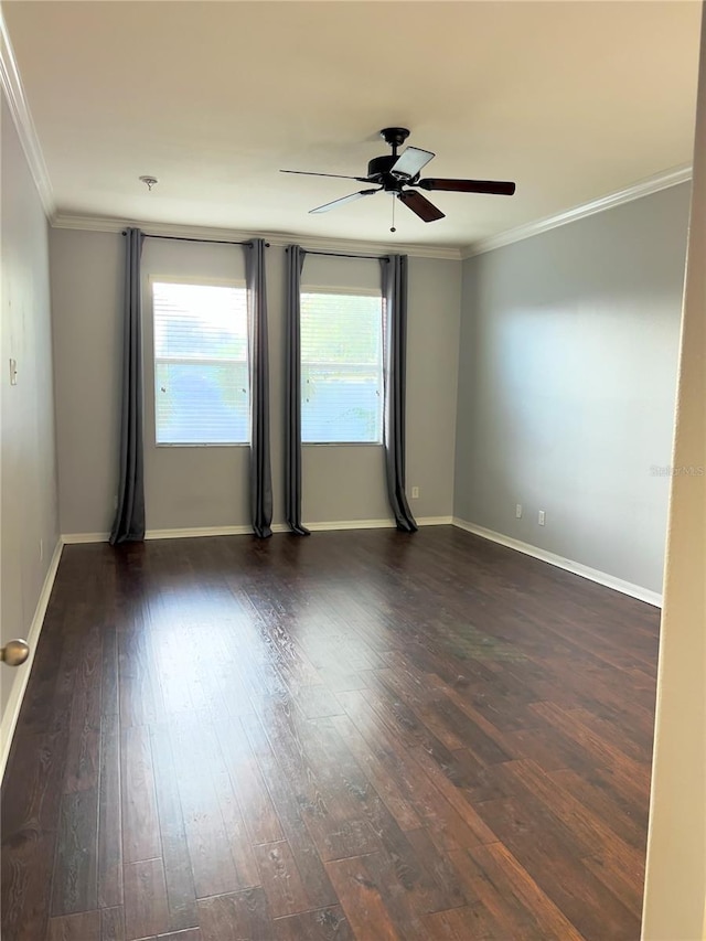 spare room with ceiling fan, baseboards, ornamental molding, and dark wood finished floors