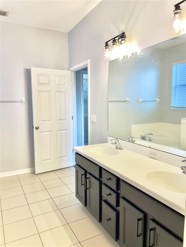 bathroom with double vanity, a sink, visible vents, and tile patterned floors