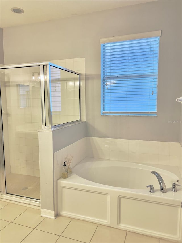 full bath with tile patterned flooring, a garden tub, and a shower stall