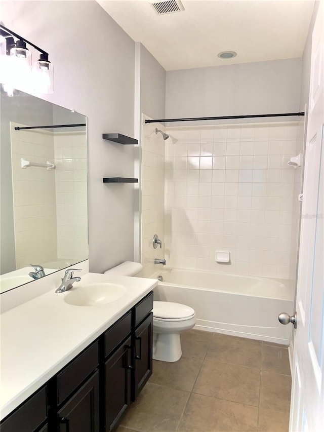 bathroom featuring shower / tub combination, toilet, visible vents, vanity, and tile patterned floors