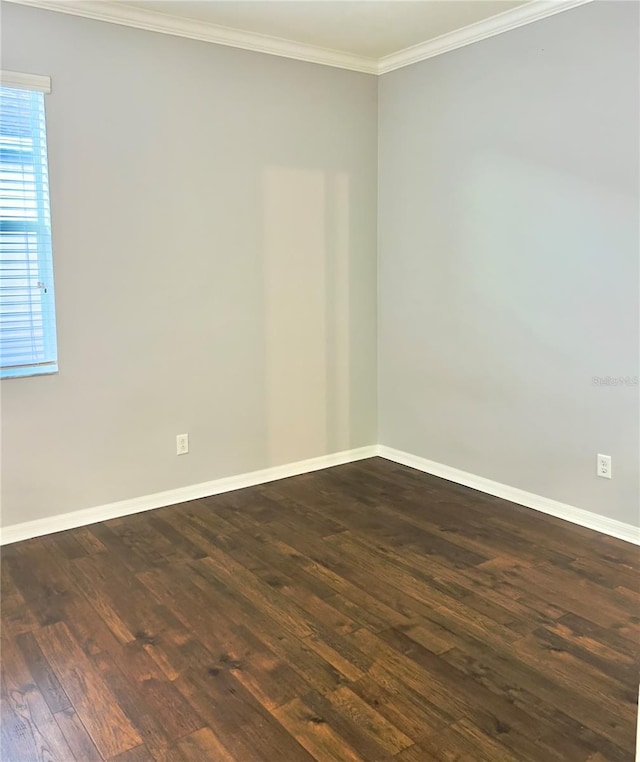 unfurnished room featuring baseboards, dark wood-style flooring, and crown molding