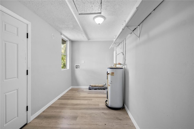 interior space with light wood-style floors and water heater