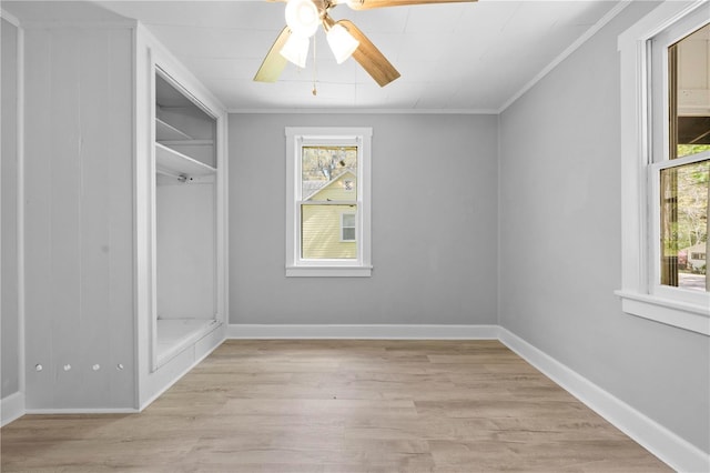 interior space with baseboards, light wood-style floors, and ornamental molding