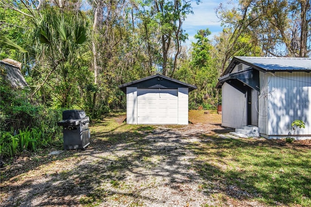 view of yard featuring a shed, entry steps, and an outdoor structure