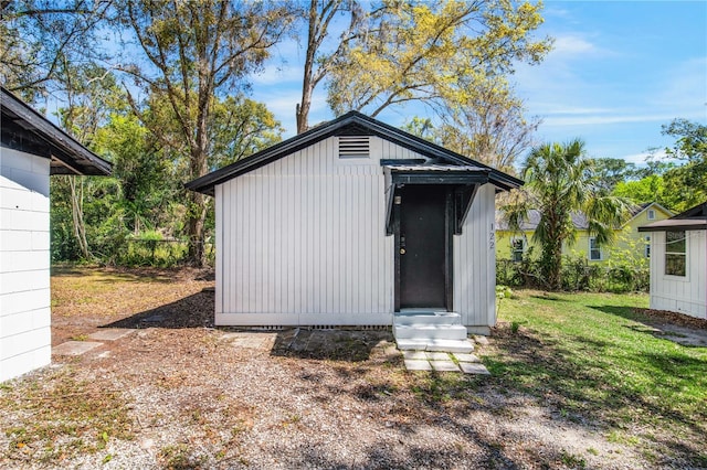 view of outbuilding featuring an outdoor structure and fence