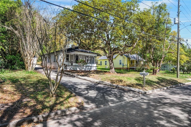 view of front of home featuring a sunroom