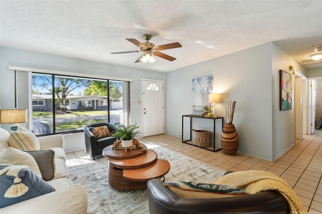 tiled living area featuring visible vents, a textured ceiling, and ceiling fan