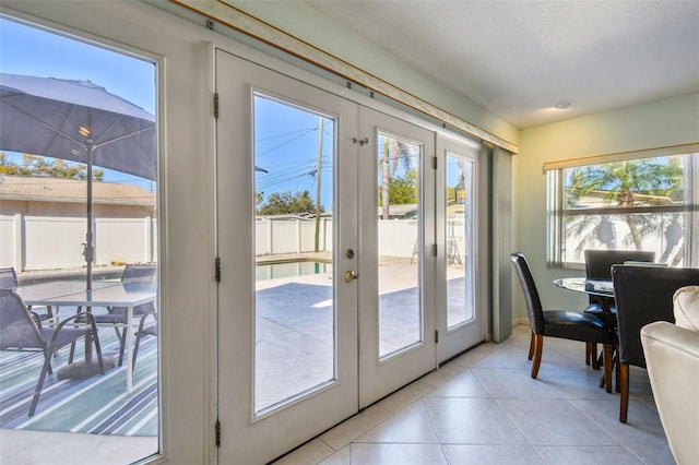 doorway featuring light tile patterned floors and french doors