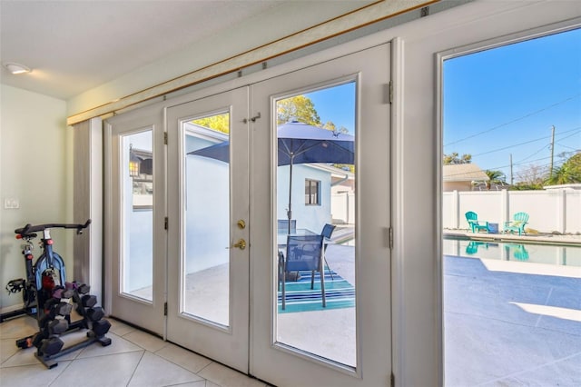 doorway to outside with light tile patterned floors, french doors, and a wealth of natural light