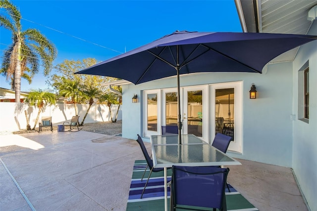 view of patio / terrace featuring fence and french doors