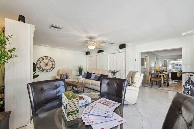 living area featuring light tile patterned floors and a ceiling fan