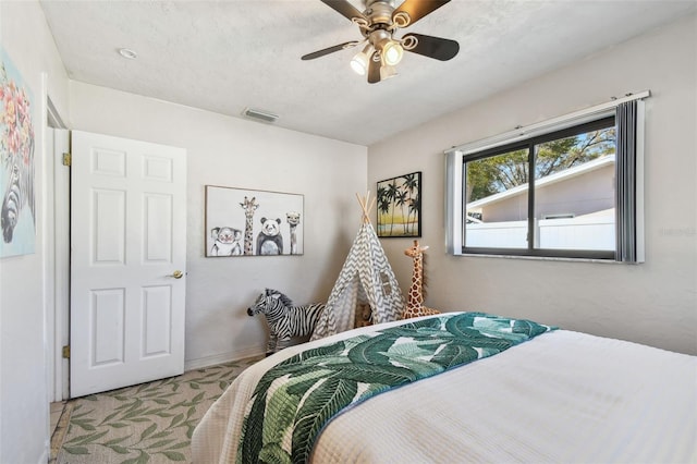 bedroom featuring baseboards, visible vents, carpet floors, and ceiling fan