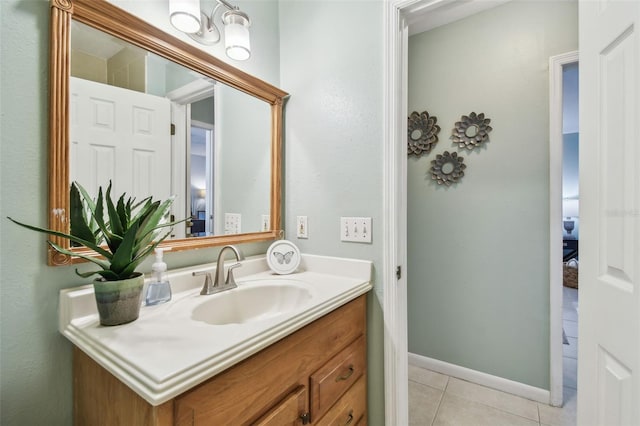 bathroom with vanity, tile patterned floors, and baseboards