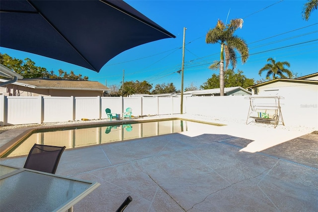 view of patio / terrace with a fenced in pool and a fenced backyard