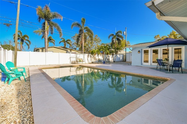 view of swimming pool with a patio area, a fenced in pool, and a fenced backyard