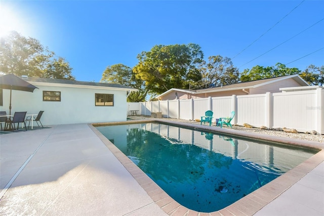 view of swimming pool featuring a patio area, a fenced in pool, and a fenced backyard