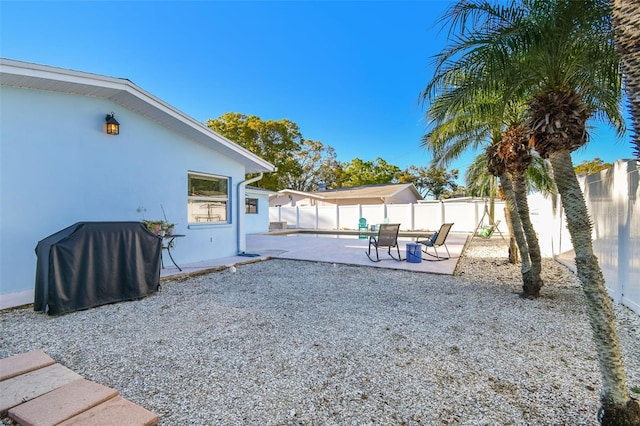 view of yard with a fenced backyard and a patio