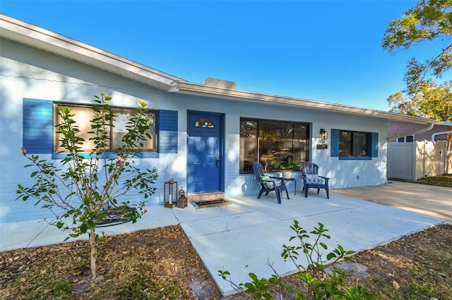 back of property with a patio and fence