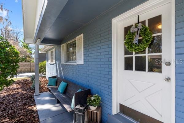 view of patio / terrace with a garage and fence