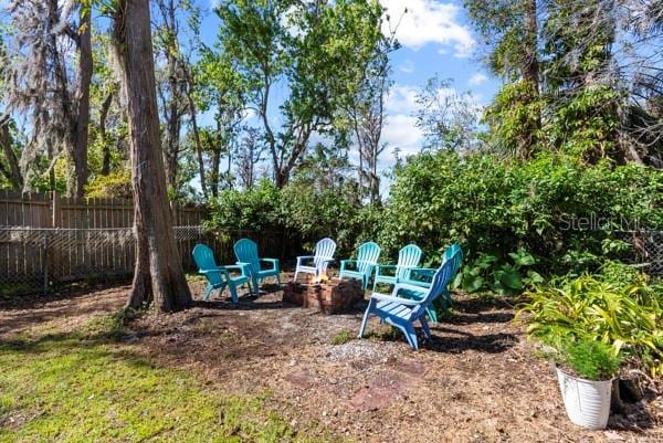 view of yard featuring fence and a fire pit