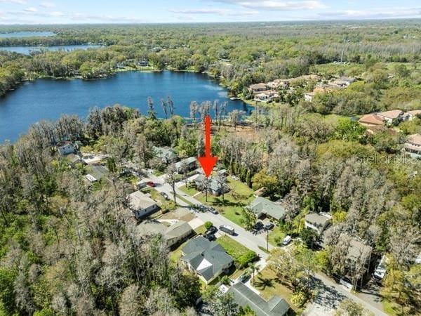 aerial view featuring a water view and a wooded view