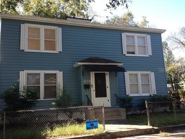 view of front of home featuring a fenced front yard and entry steps