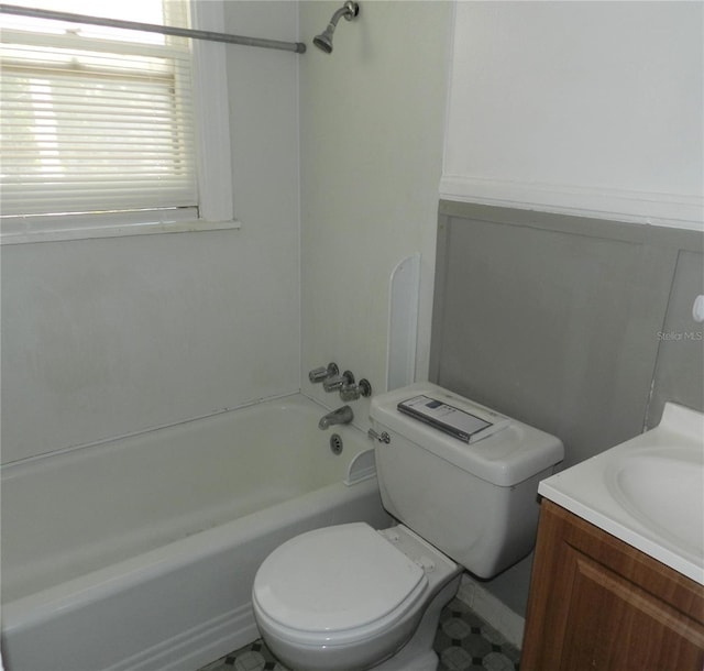 bathroom featuring vanity, toilet, and washtub / shower combination