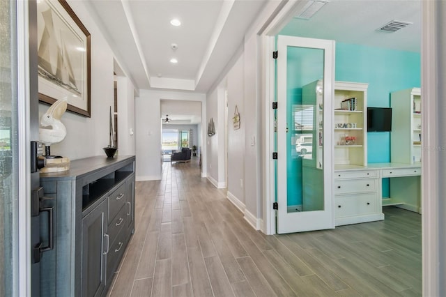 corridor featuring visible vents, recessed lighting, light wood-type flooring, and baseboards