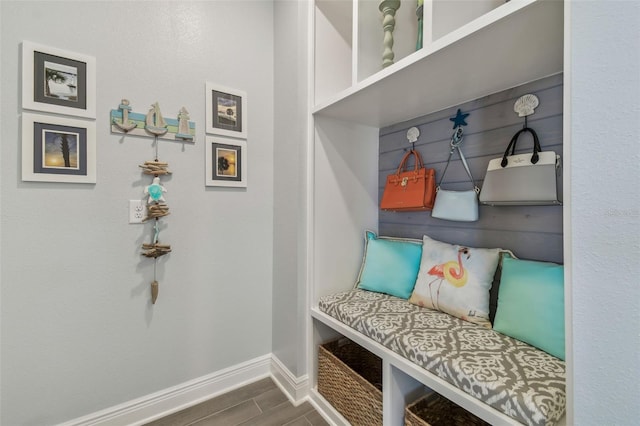 mudroom featuring baseboards and wood finish floors