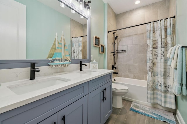 full bathroom with double vanity, shower / bath combination with curtain, toilet, and a sink