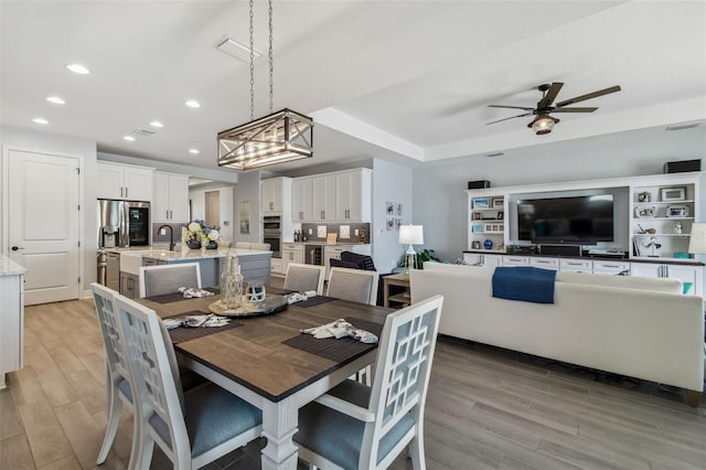 dining area with recessed lighting, visible vents, a ceiling fan, and light wood finished floors