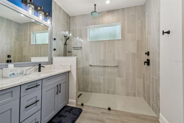 full bath with walk in shower and vanity