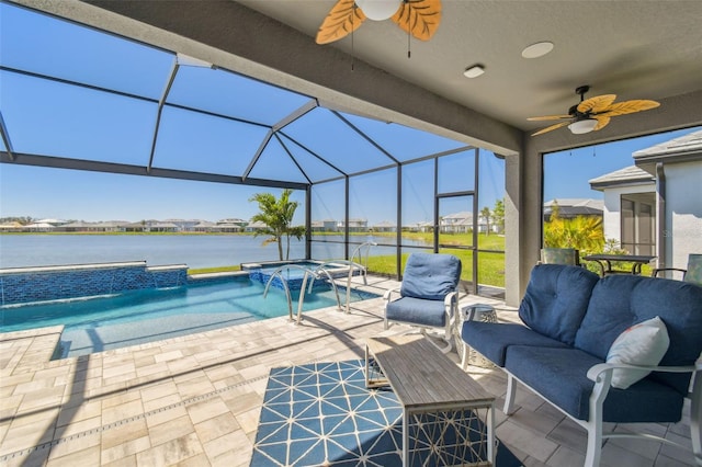 view of pool with a water view, a pool with connected hot tub, a patio, glass enclosure, and an outdoor hangout area