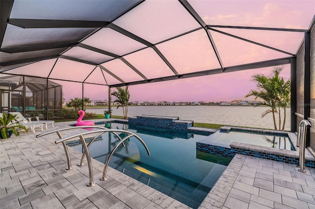 view of pool with a patio, a pool with connected hot tub, a lanai, and a water view