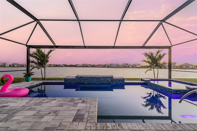 view of swimming pool featuring a patio, a pool with connected hot tub, a lanai, and a water view