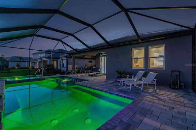 view of swimming pool featuring a patio, a lanai, and a pool with connected hot tub