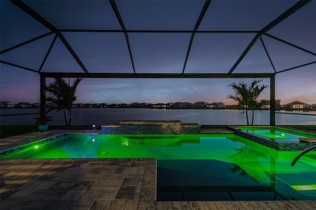 view of swimming pool featuring glass enclosure, a patio area, and a pool with connected hot tub